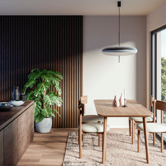 Chocolate brown wooden acoustic panels on a dining room wall. Interior has a wooden dining table with chairs, a kitchen counter and a large plant