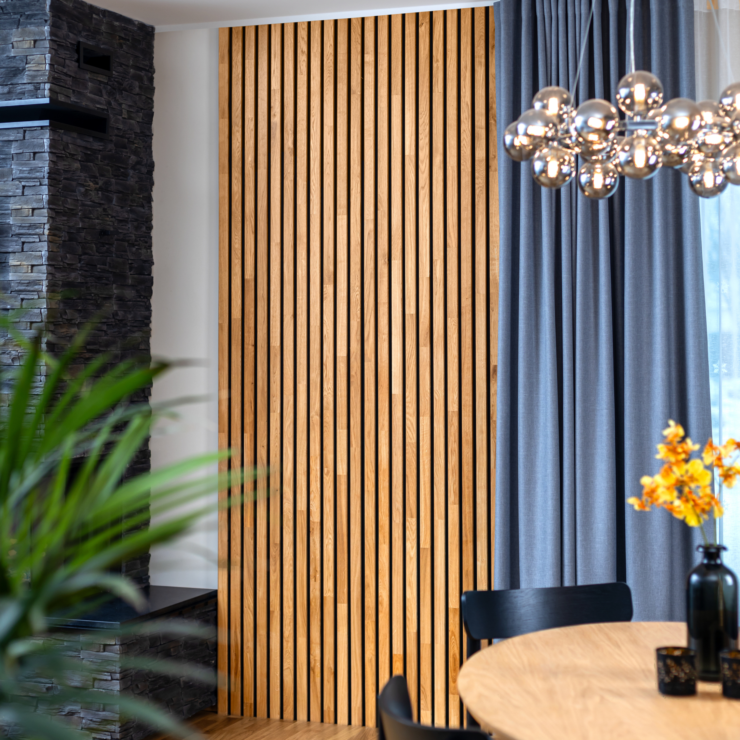 Natural oak wooden panels on a dining room wall with solid wood table and chairs in the front