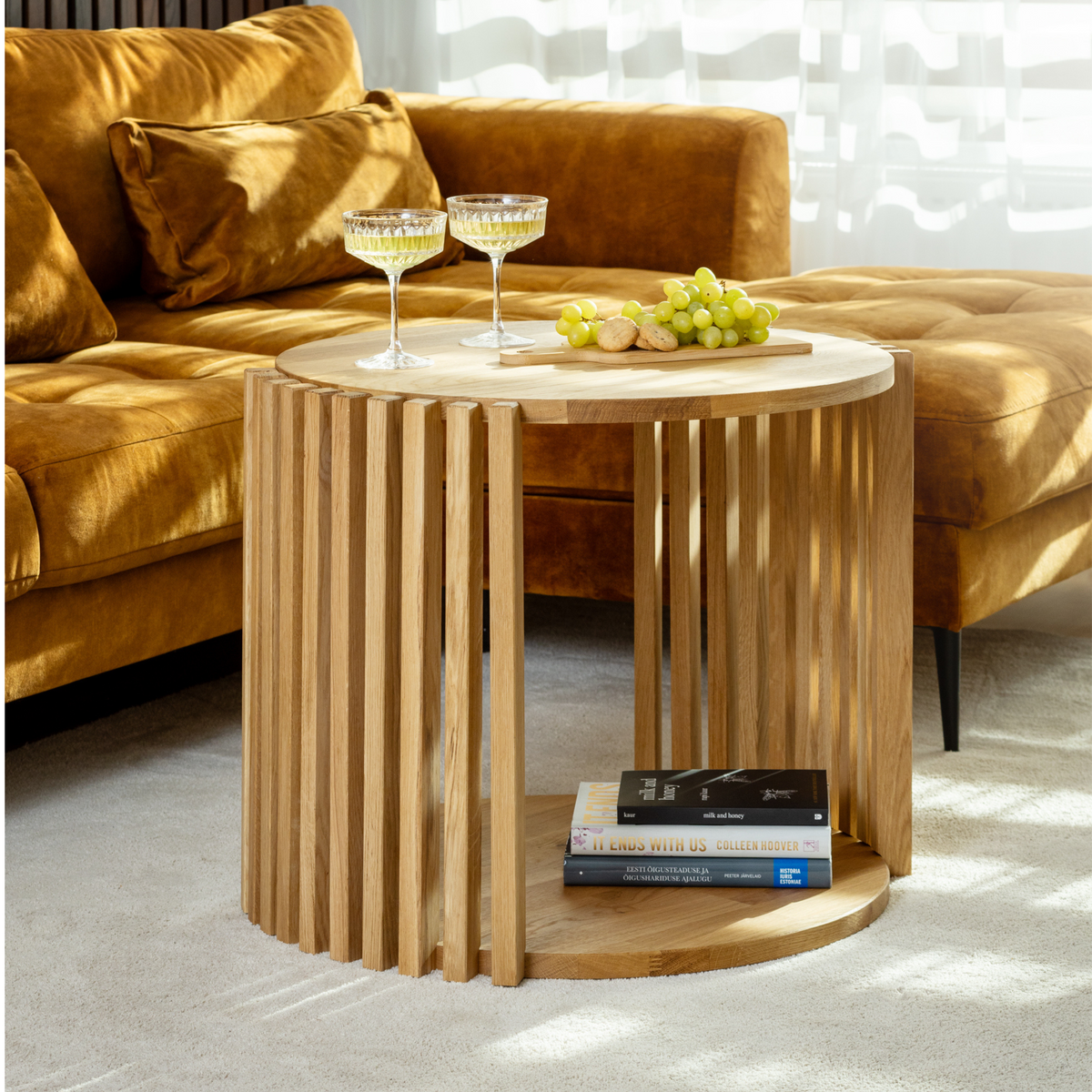 The KOHVI coffee table styled with books and a wine glass for a cozy setting