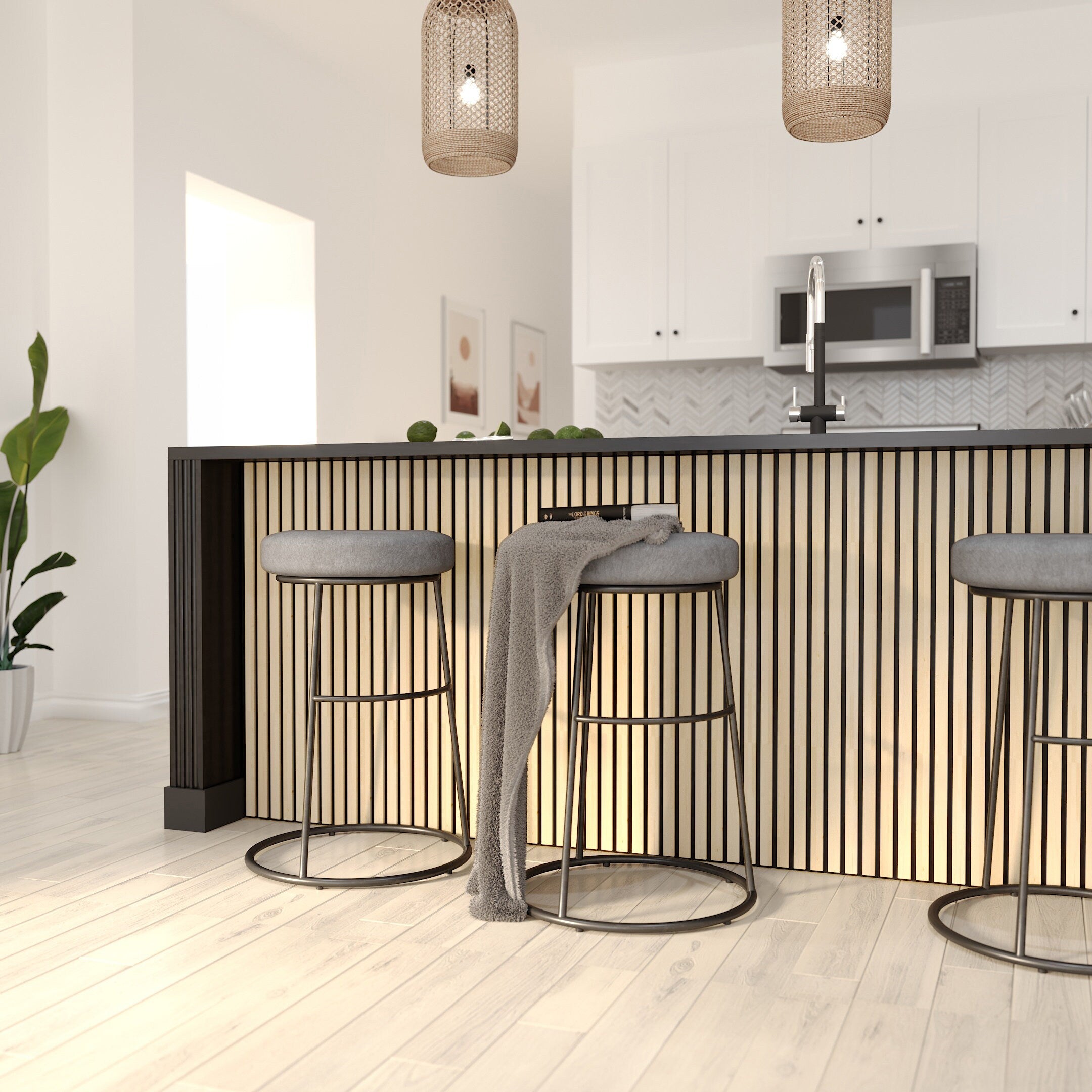 Light natural birch wood acoustic panels attached to a kitchen counter wall. Kitchen in the background and metal legged bar chairs in front of the counter