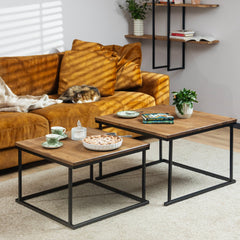 The Nurmenukk coffee table styled with books, a flower, a pie and mugs for a cozy living room setting