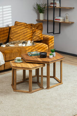 The HEX coffee table styled with books, tea and a candle for a cozy setting. A cat is sleeping in the background on the couch.