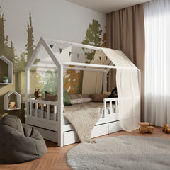 White wooden housebed ÖÖBIK with two drawers in a modern and bright kids room decorated with pillows and toys