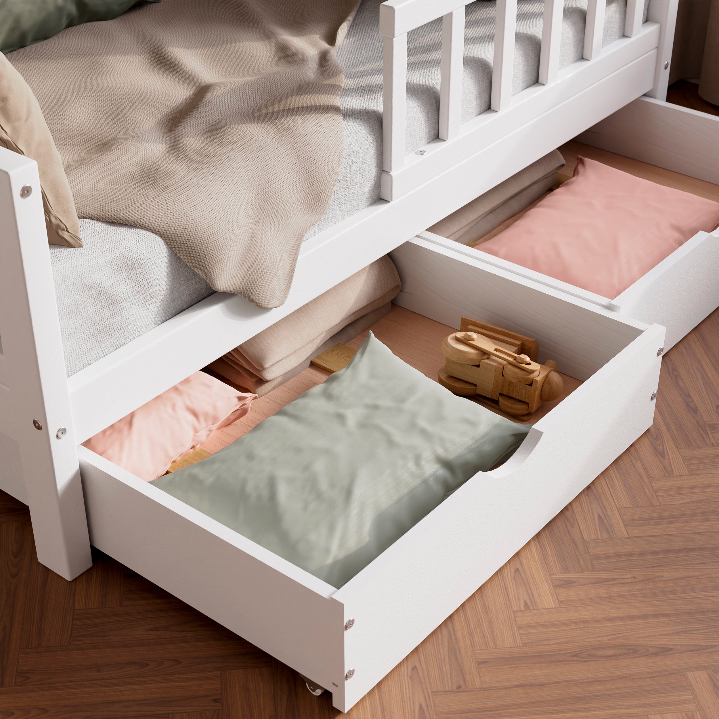 Close up view of the white solid wood toddler bed VARBLANE with drawers highlighting the two drawers pulled out