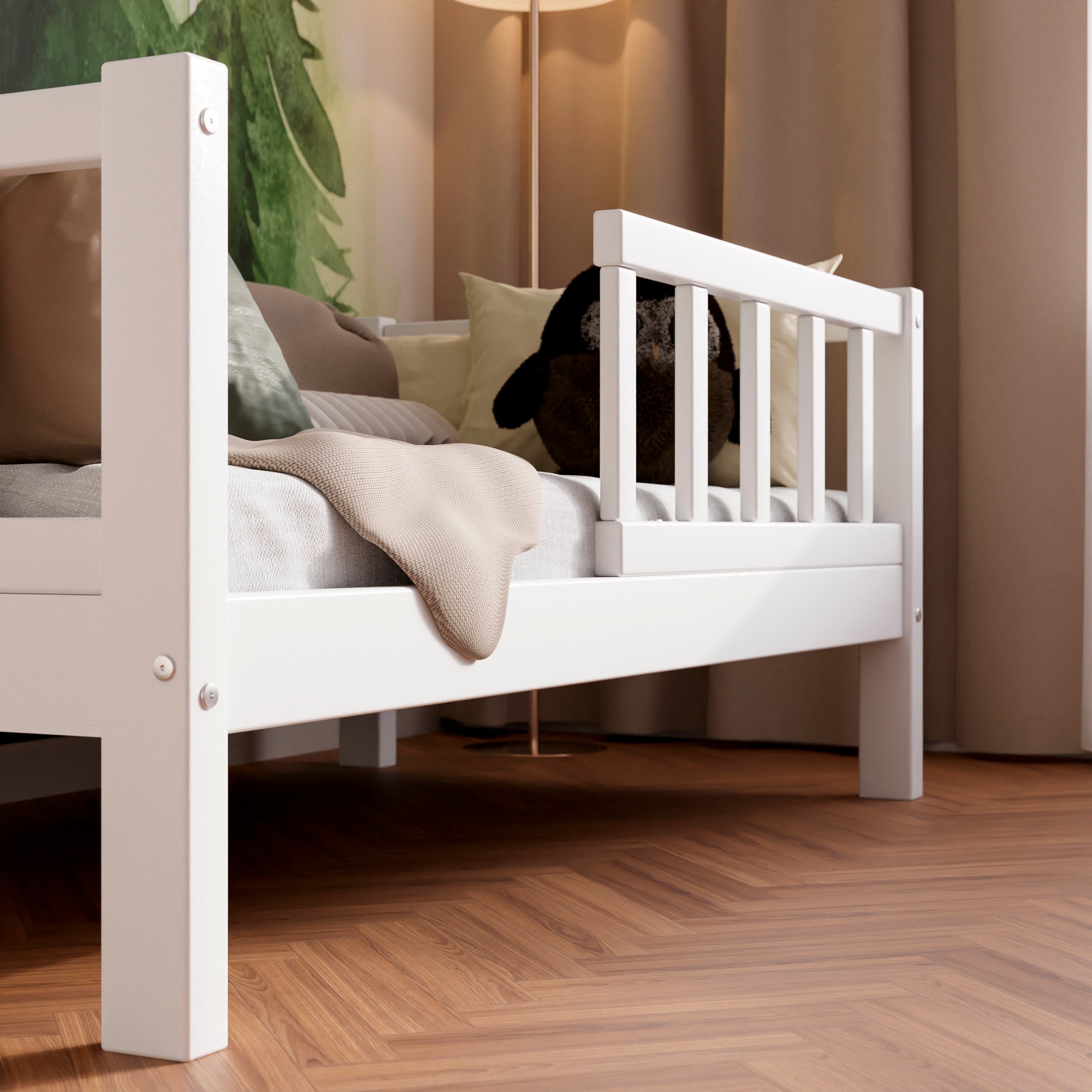 Close up view of the white solid wood kids bed highlighting the barriers