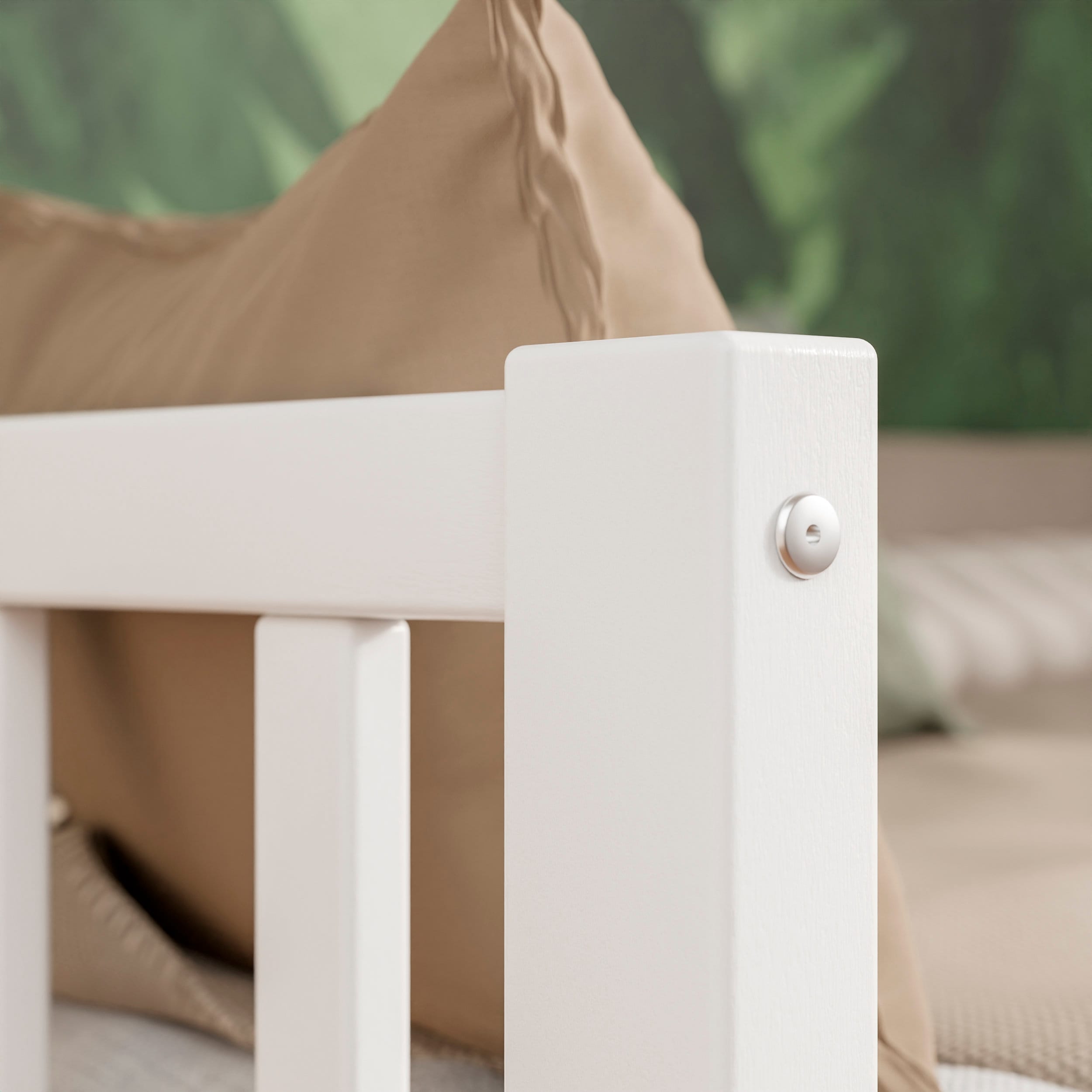 Close up view of the white solid wood toddler bed VARBLANE highlighting the attachments 