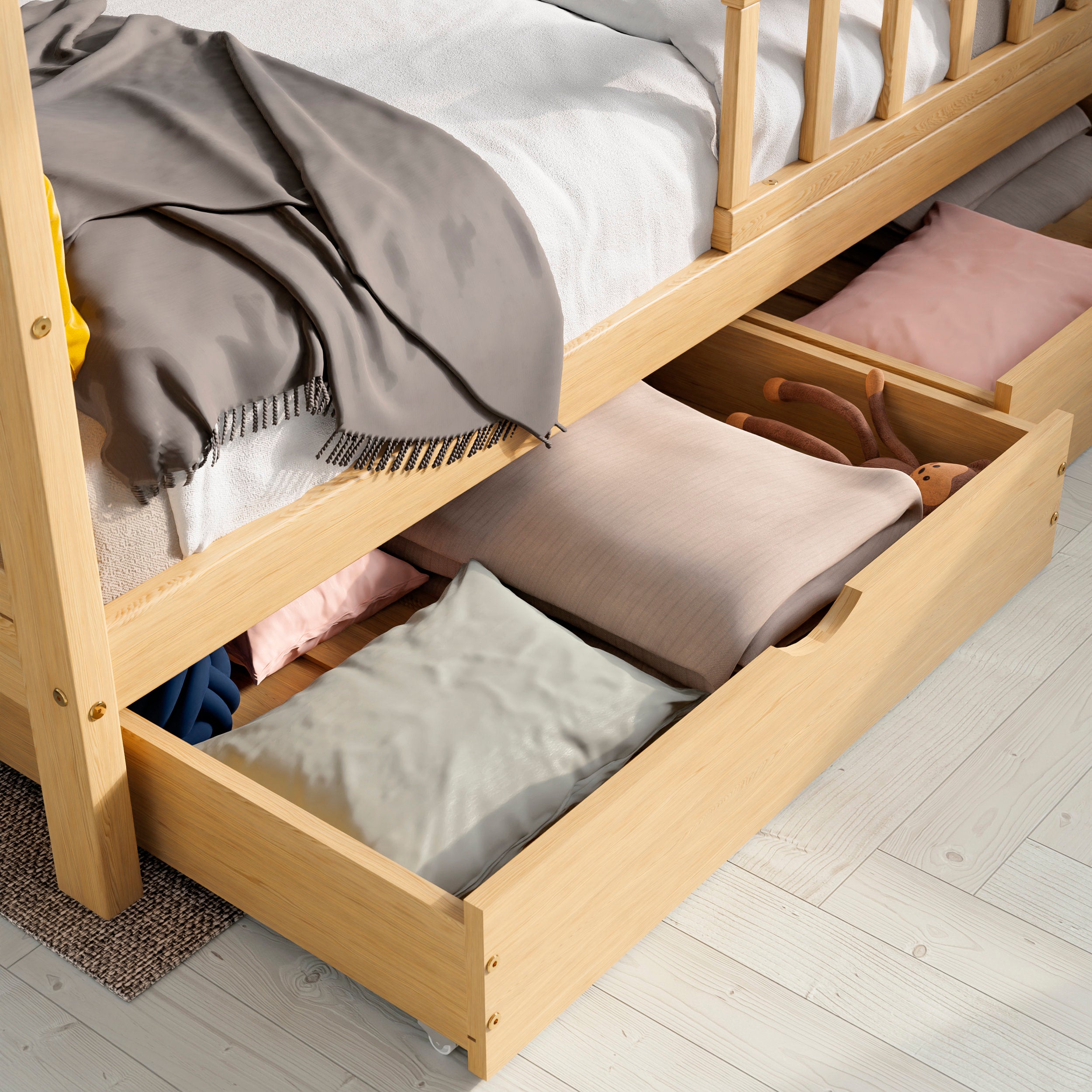 Close up view of the ÖÖBIK natural housebed showing the drawers opened