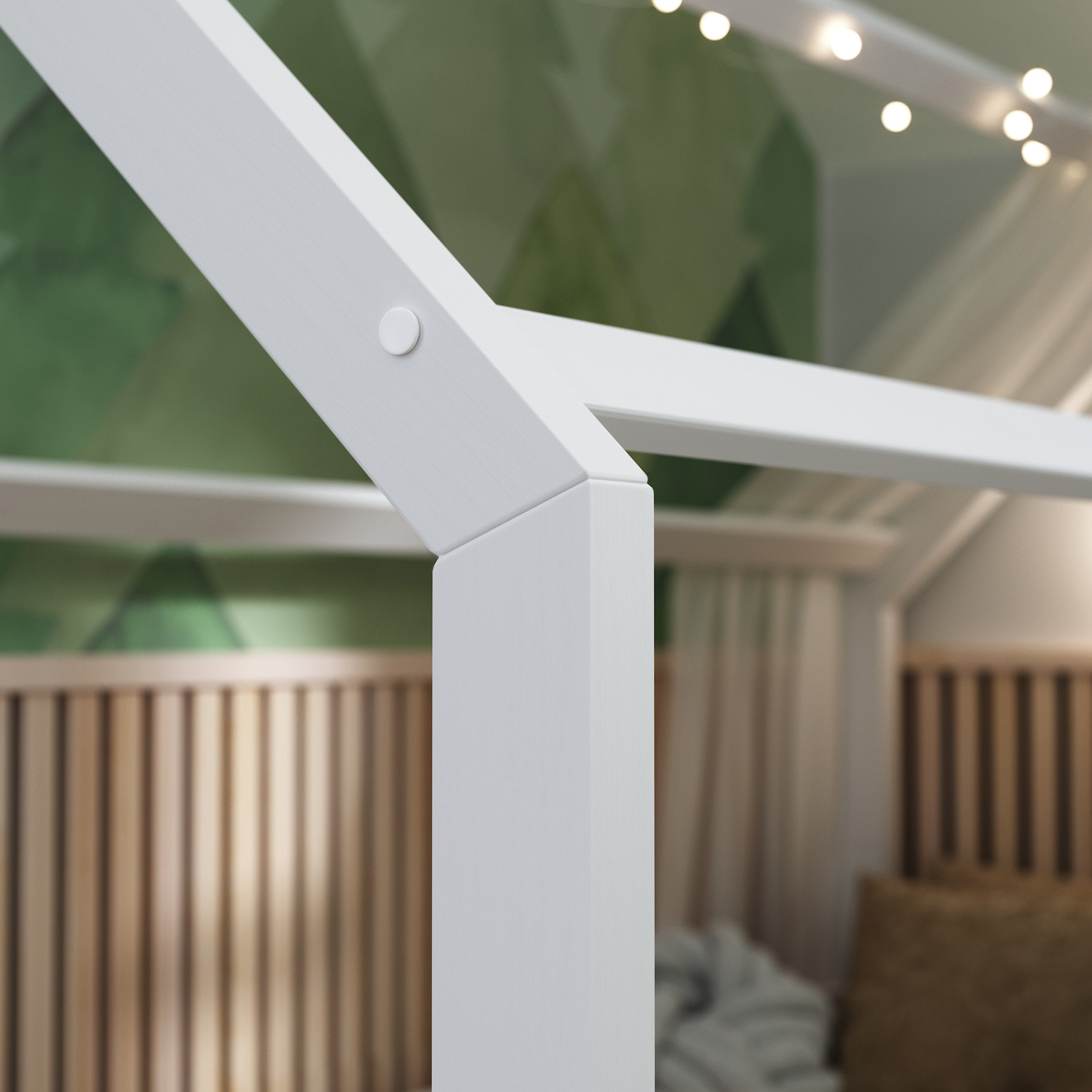 Close up view of the ÖÖBIK white montessori bed showing the attachment style of the kids bed 