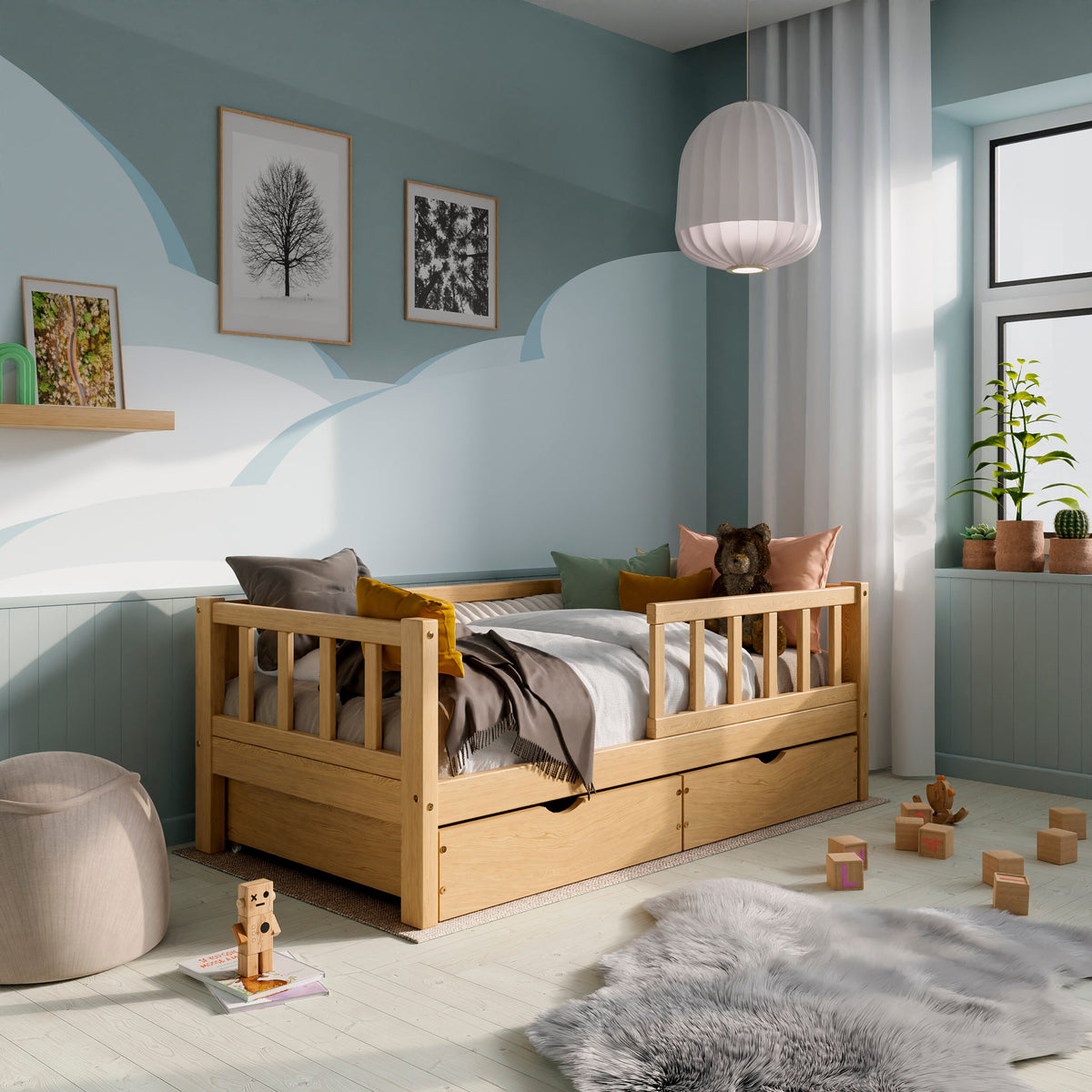 Wooden toddler bed with barriers, drawers and a pull-out bed in a kids room decorated with pillows and toys