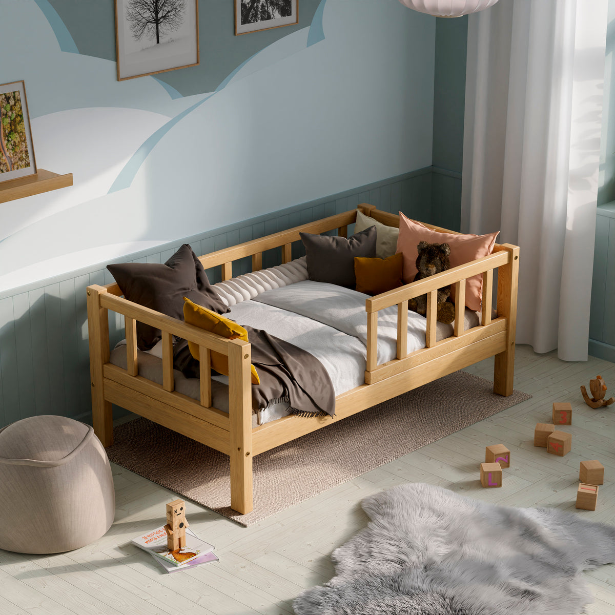 Wooden toddler bed with barriers in a kids room decorated with pillows and toys