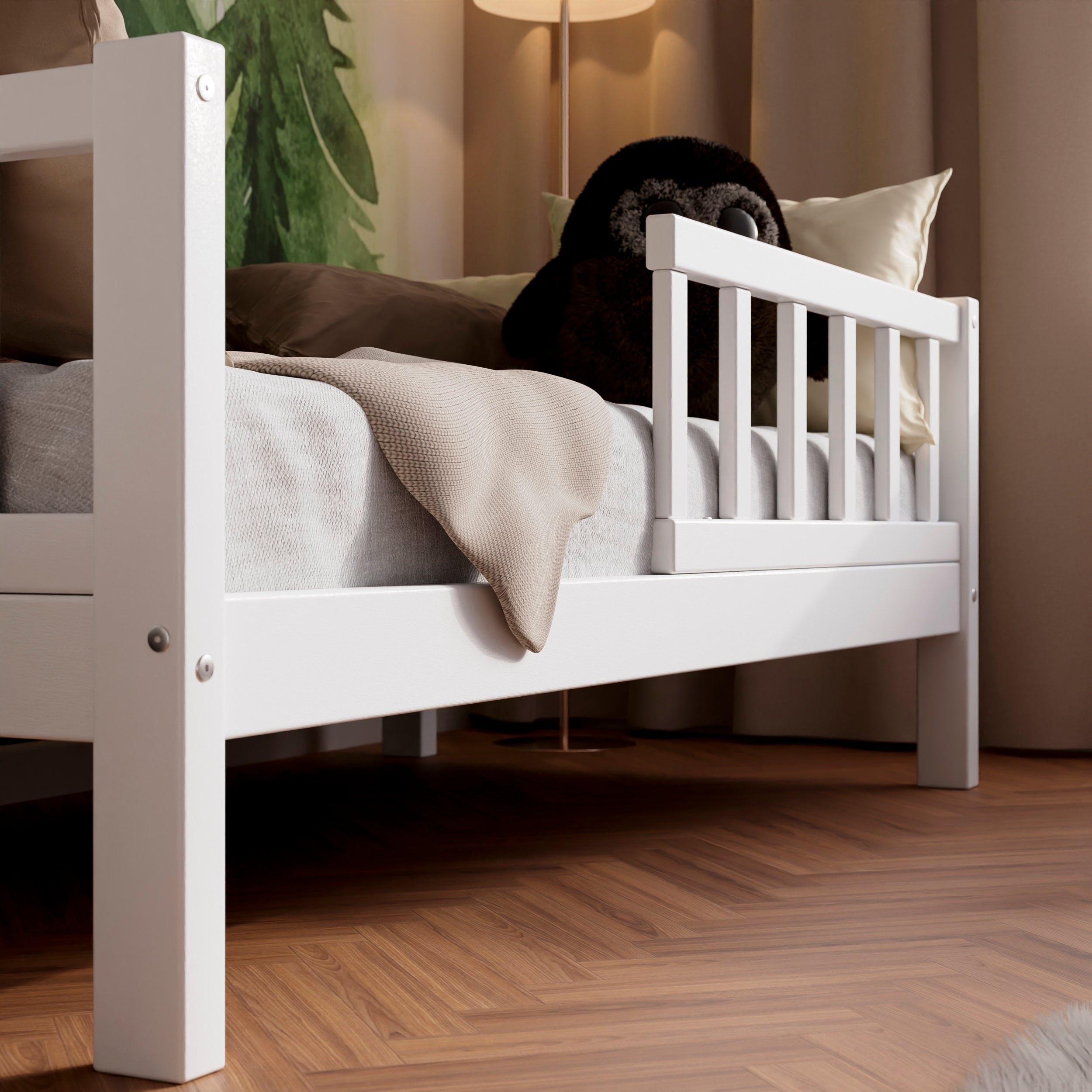 Close up view of the white wooden toddler bed VARBLANE with barriers in a kids room 