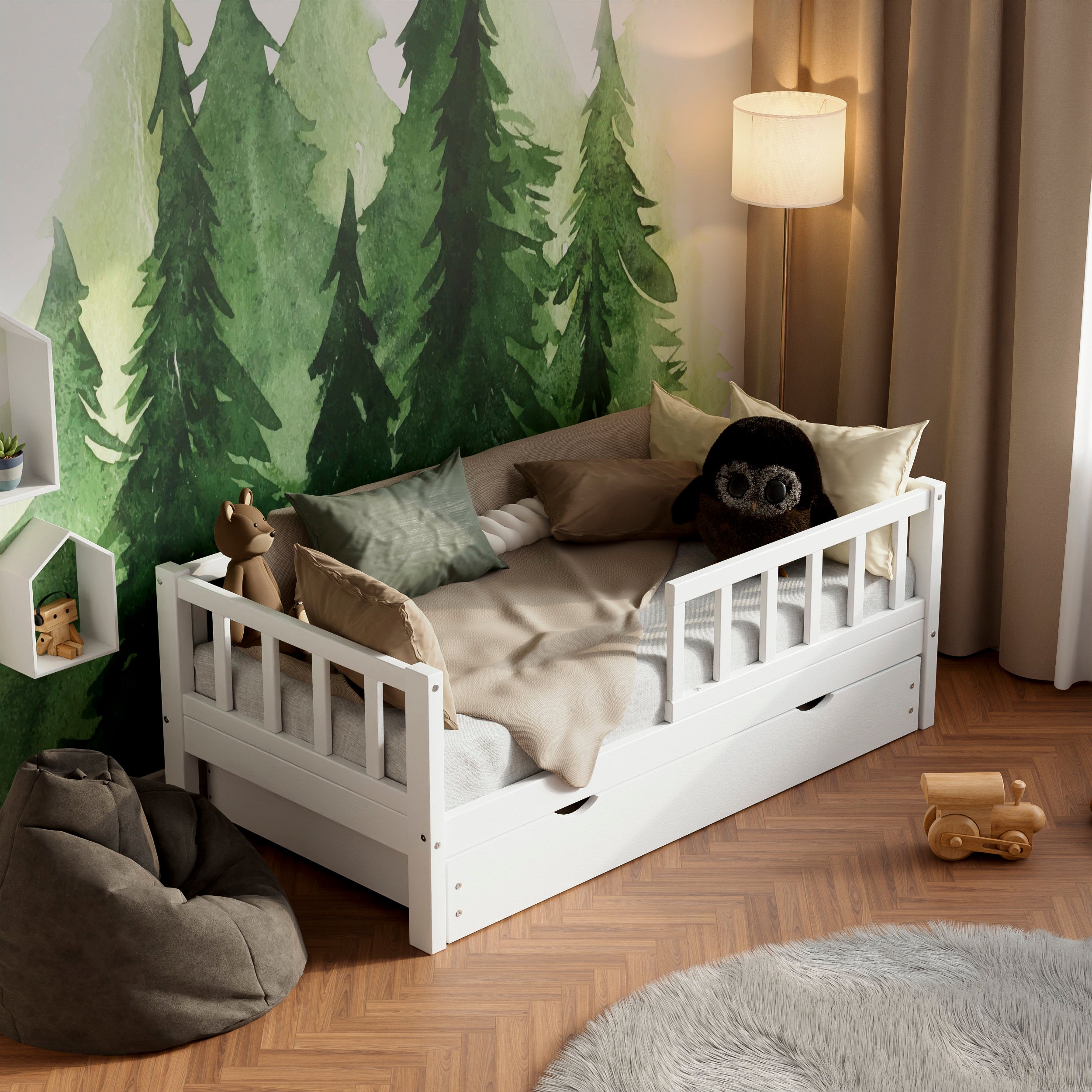 White wooden toddler bed VARBLANE with barriers, drawers and a pull-out bed in a kids room decorated with pillows and toys